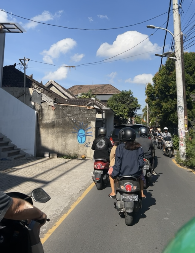 People on scooters in a traffic jam on the road