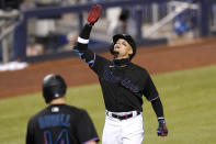 Miami Marlins' Isan Diaz reacts as he crosses the plate to score after hitting a grand slam during the third inning of a baseball game against the Miami Marlins, Friday, May 7, 2021, in Miami. (AP Photo/Lynne Sladky)