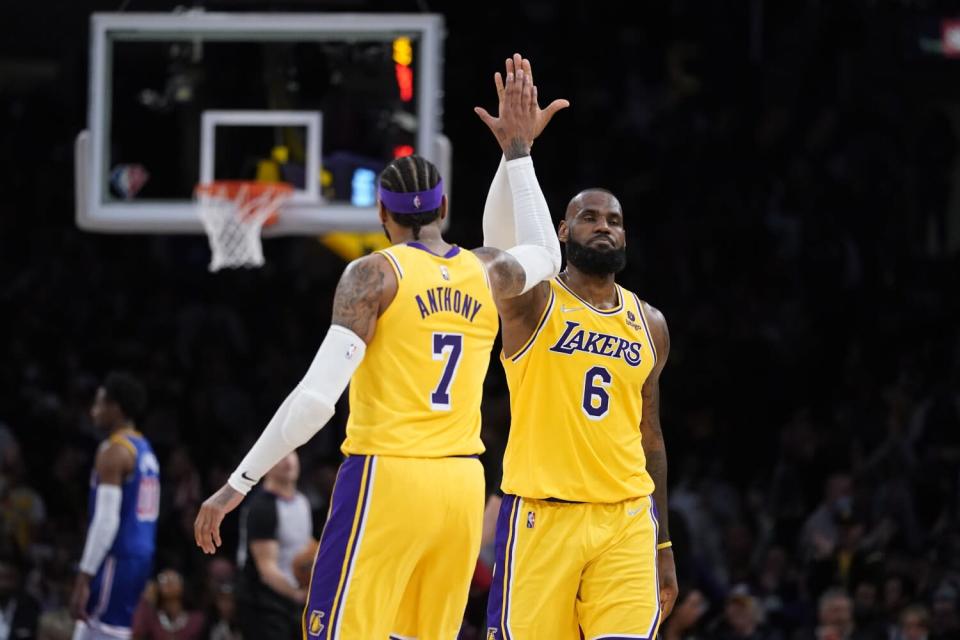 Lakers forward Carmelo Anthony high-fives forward LeBron James.