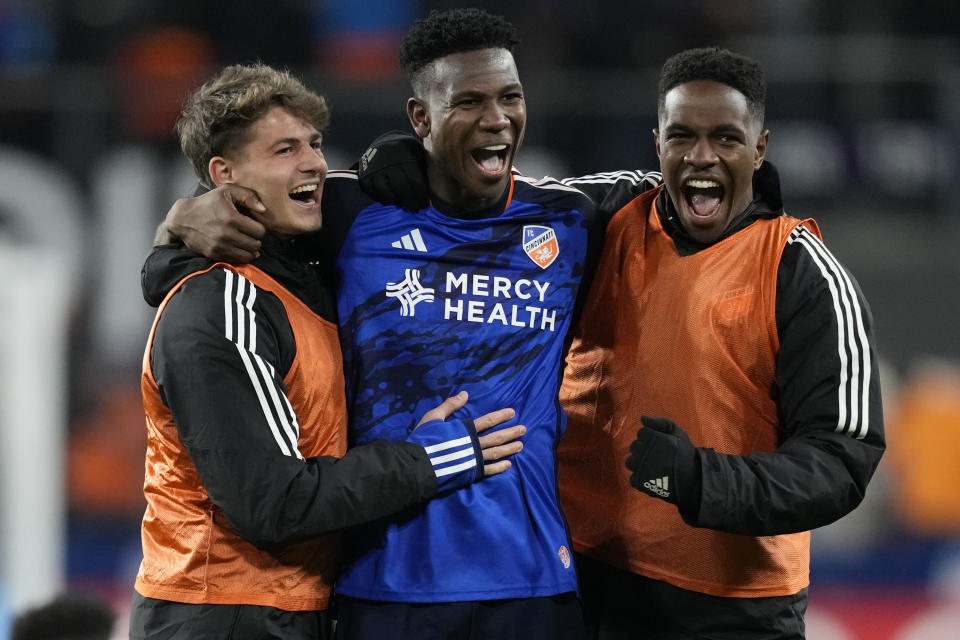 FC Cincinnati's Bret Halsey, Yerson Mosquera and Malik Pinto, from left, celebrate the team's win over the Philadelphia Union in an MLS Eastern Conference soccer playoff semifinal, Saturday, Nov. 25, 2023, in Cincinnati. (AP Photo/Carolyn Kaster)