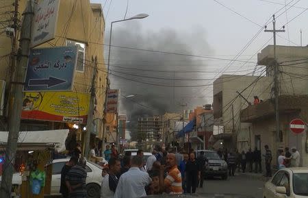 Smoke rises from the site of a bomb attack in Erbil, the capital of Iraq's Kurdistan region, April 17, 2015. REUTERS/Stringer