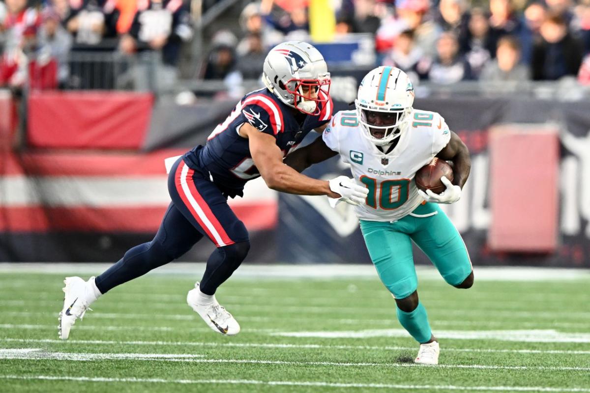 Miami Dolphins wide receivers Jaylen Waddle (17) and Tyreek Hill (10) walk  off the field during the second half of an NFL football game against the  New England Patriots, Sunday, Sept. 11