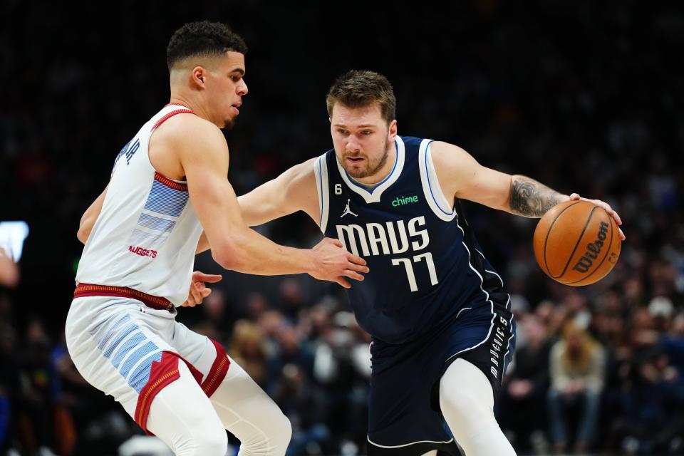 Dallas Mavericks guard Luka Doncic (77) drives at Denver Nuggets forward Michael Porter Jr. (1). The Nuggets will host the Mavericks on the opening night of the NBA in-season tournament.