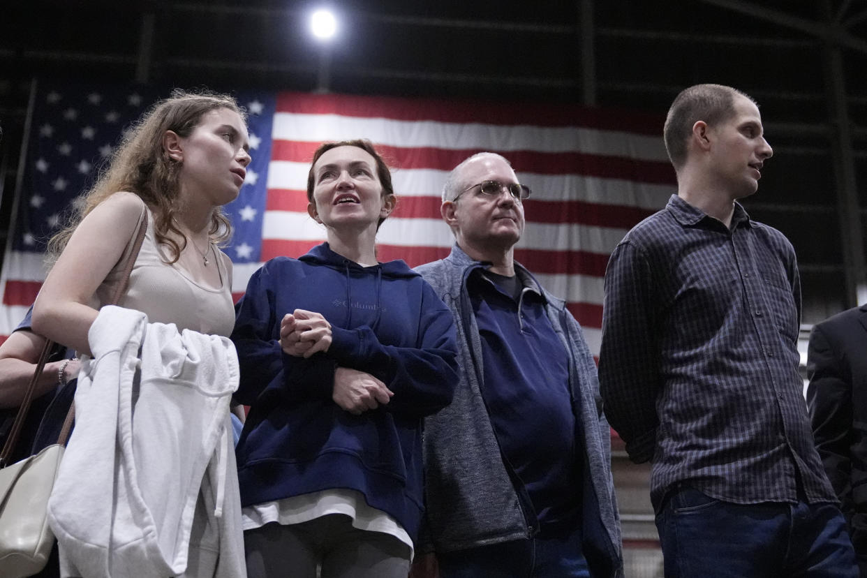 Kurmasheva stands with Whelan and Gershkovich, right, after they arrived at Kelly Field in San Antonio, where they'll undergo medical evaluations.