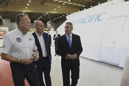 International Trade Secretary Liam Fox (R) views a passenger cabin crew simulator during his visit to EDM Ltd in Newton Heath, Manchester, Britain September 29, 2016. REUTERS/Anthony Devlin