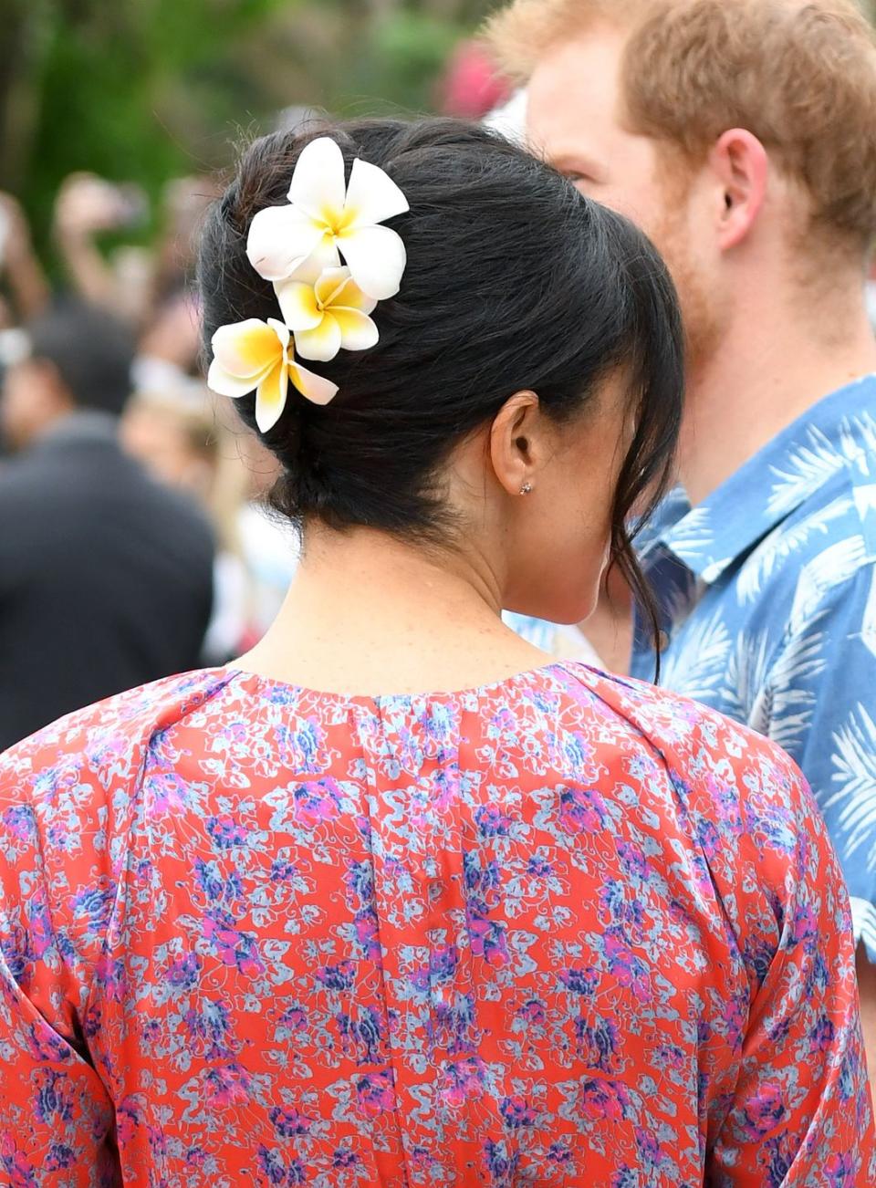 Meghan wearing traditional Fiji Frangipani flowers in her updo in 2018