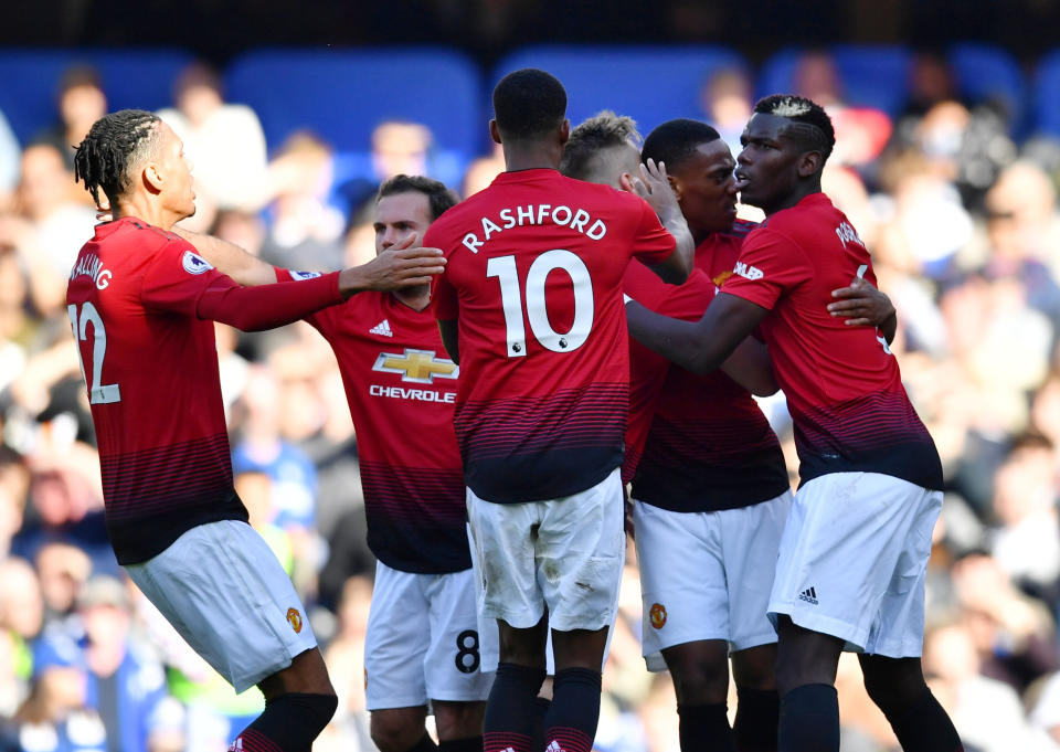 Manchester United players celebrate Anthony Martial’s equaliser at Chelsea