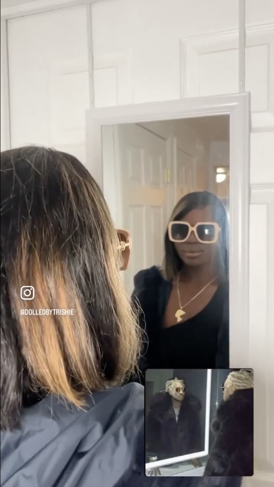 person wearing a jacket and sunglasses looking in the mirror