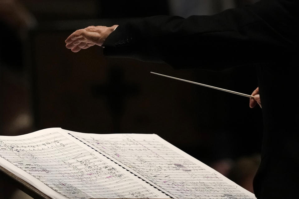 The hands and baton of Riccardo Muti, musical director of the Chicago Symphony Orchestra glides over the marked up score as he conducts the orchestra and chorus in Beethoven's "Missa Solemnis" in D Major, Op. 123, Sunday, June 25, 2023, in Chicago. Sunday marked the last performance by Muti, 81, in Orchestra Hall during his 13 year tenure. (AP Photo/Charles Rex Arbogast)