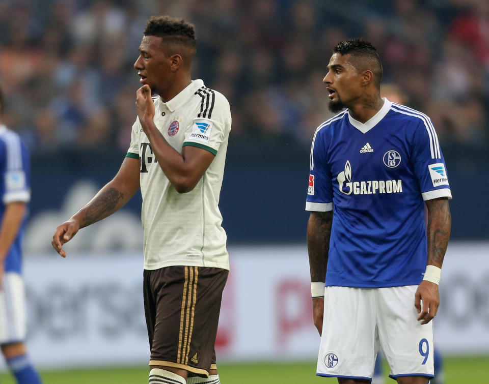 GELSENKIRCHEN, GERMANY - SEPTEMBER 21: Jerome Boateng of Munich (L) stands close to his brother Kevin-Prince Boateng of Schalke during the Bundesliga match between FC Schalke 04 and FC Bayern Muenchen at Veltins-Arena on September 21, 2013 in Gelsenkirchen, Germany.  (Photo by Juergen Schwarz/Bongarts/Getty Images)
