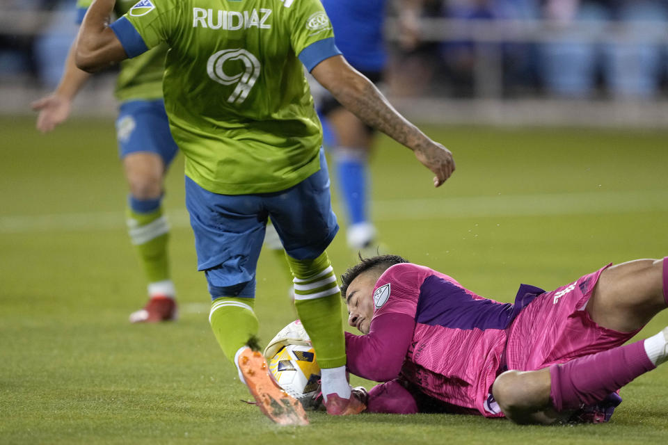 San Jose Earthquakes goalkeeper JT Marcinkowski (1) blocks a shot by Seattle Sounders forward Raul Ruidiaz (9) during the first half of an MLS soccer match Wednesday, Sept. 29, 2021, in San Jose, Calif.(AP Photo/Tony Avelar)