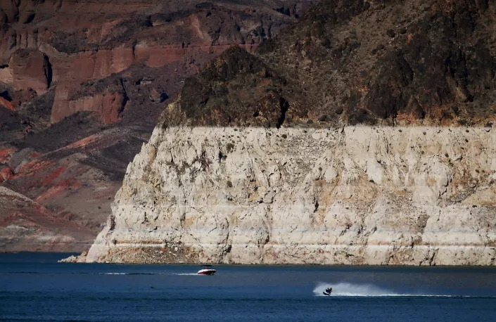 Boaters are dwarfed by a white &quot;bathtub ring&quot; around Lake Mead.