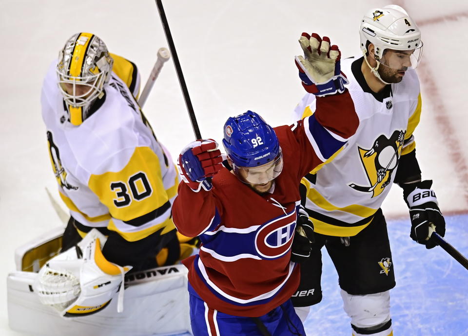 Montreal Canadiens' Jonathan Drouin (92) celebrates his goal on Pittsburgh Penguins goaltender Matt Murray (30) as Penguins' Justin Schultz (4) looks on during the second period of an NHL hockey playoff game Wednesday, Aug. 5, 2020 in Toronto. (Frank Gunn/The Canadian Press via AP)