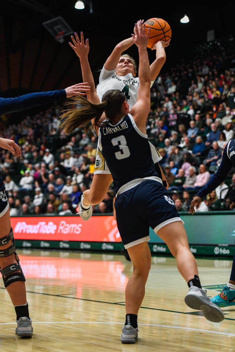 Colorado State's McKenna Hofschild (4) is fouled on a layup attempt in a women's college basketball game against Utah State at Moby Arena on Feb. 2.