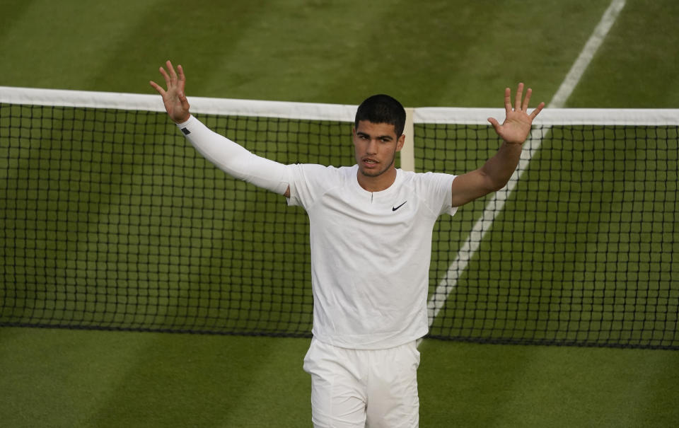 Spain's Carlos Alcaraz celebrates defeating Tallon Griekspoor of the Netherlands in a second round men's singles match on day three of the Wimbledon tennis championships in London, Wednesday June 29, 2022. (AP Photo/Alberto Pezzali)