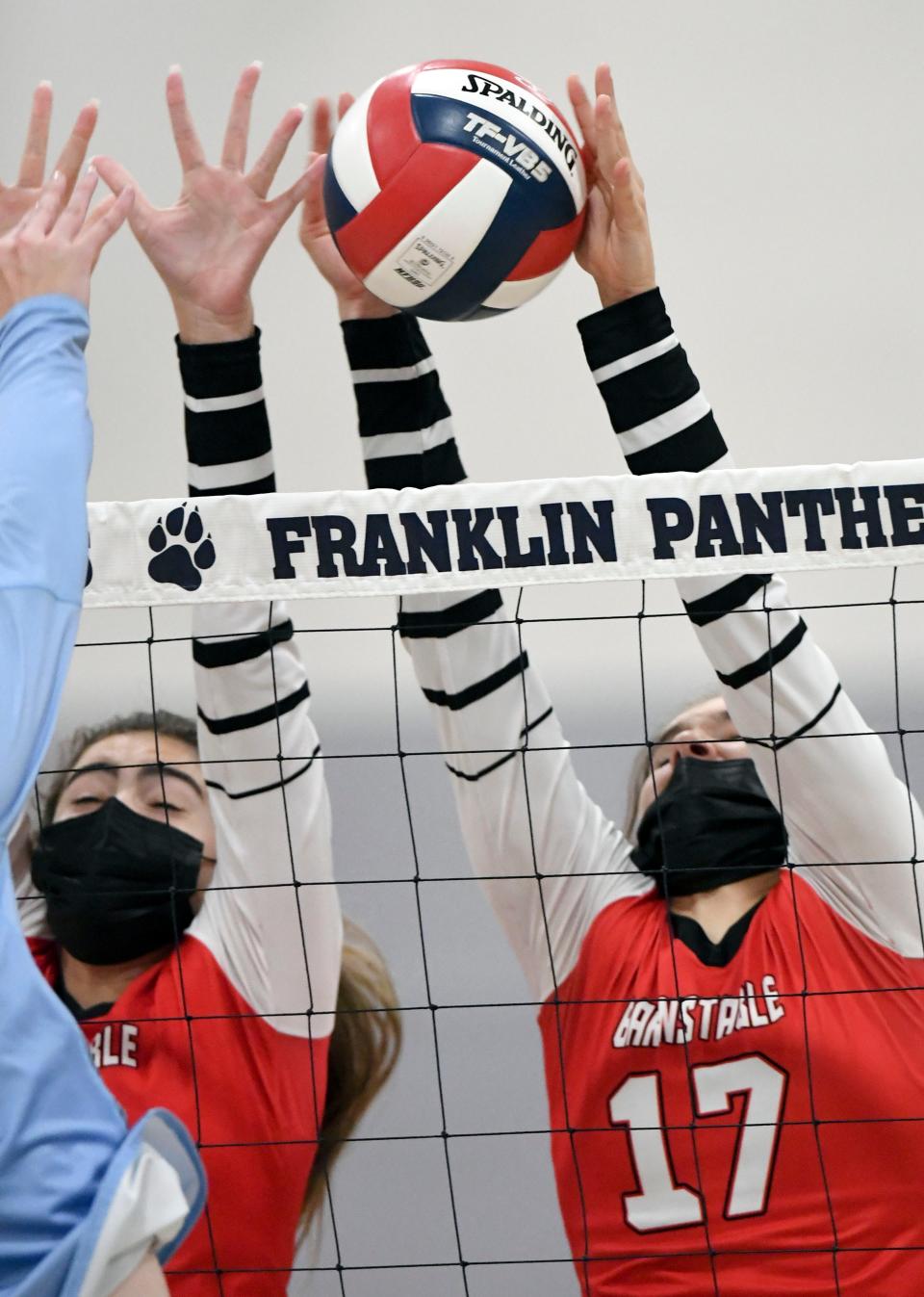 Allison Nystrom (17) and Charlotte Sullivan of Barnstable go up to block a Franklin shot in the MIAA Division 1 round of 8 volleyball match last November in Franklin.