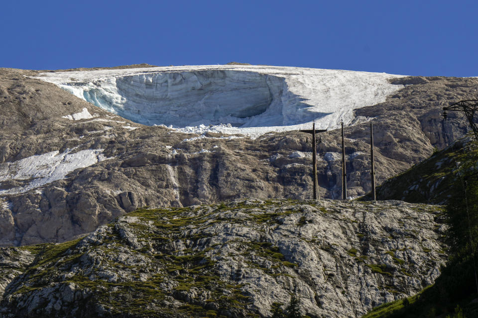 A view of the Punta Rocca glacier near Canazei, in the Italian Alps in northern Italy, Monday, July 4, 2022, a day after a huge chunk of the glacier broke loose, sending an avalanche of ice, snow, and rocks onto hikers. Rescuers said conditions downslope from the glacier, which has been melting for decades, were still too unstable to immediately send rescuers and dogs into the area to look for others buried under tons of debris. (AP Photo/Luca Bruno)