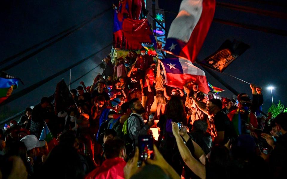 Demonstrators supporting the reform of the Chilean constitution celebrate while waiting for the referendum official results  - AFP