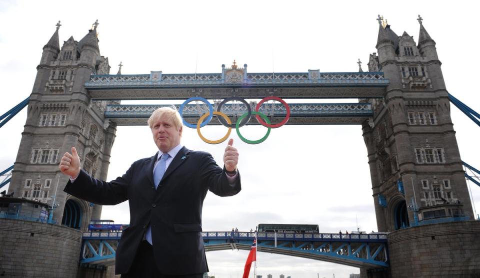 Then London mayor Boris Johnson in front of Tower Bridge in London where the Olympic rings were hung (Stefan Rousseau/PA) (PA Archive)