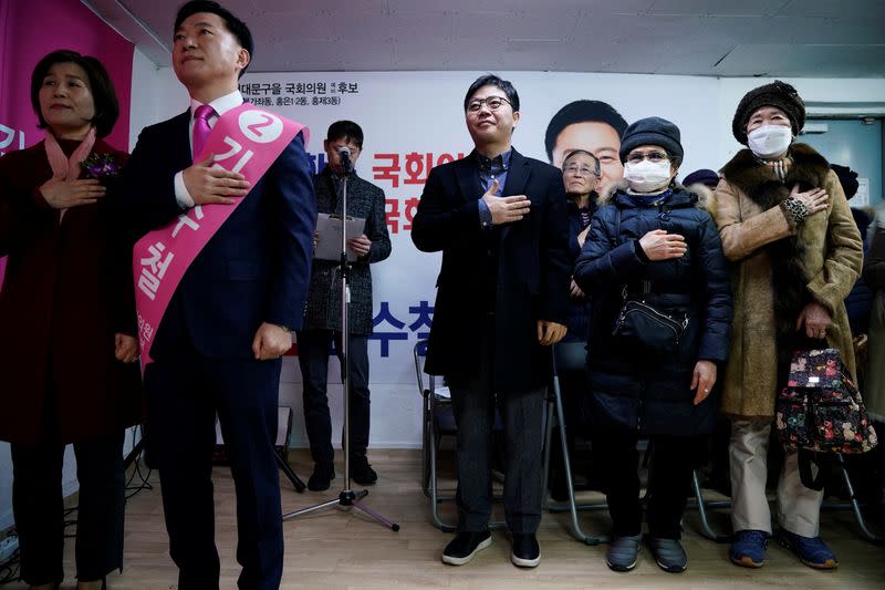 North Korean defector Ji Seong-ho salutes to a national flag during an opening ceremony for an election campaign of the main opposition United Future Party in Seoul