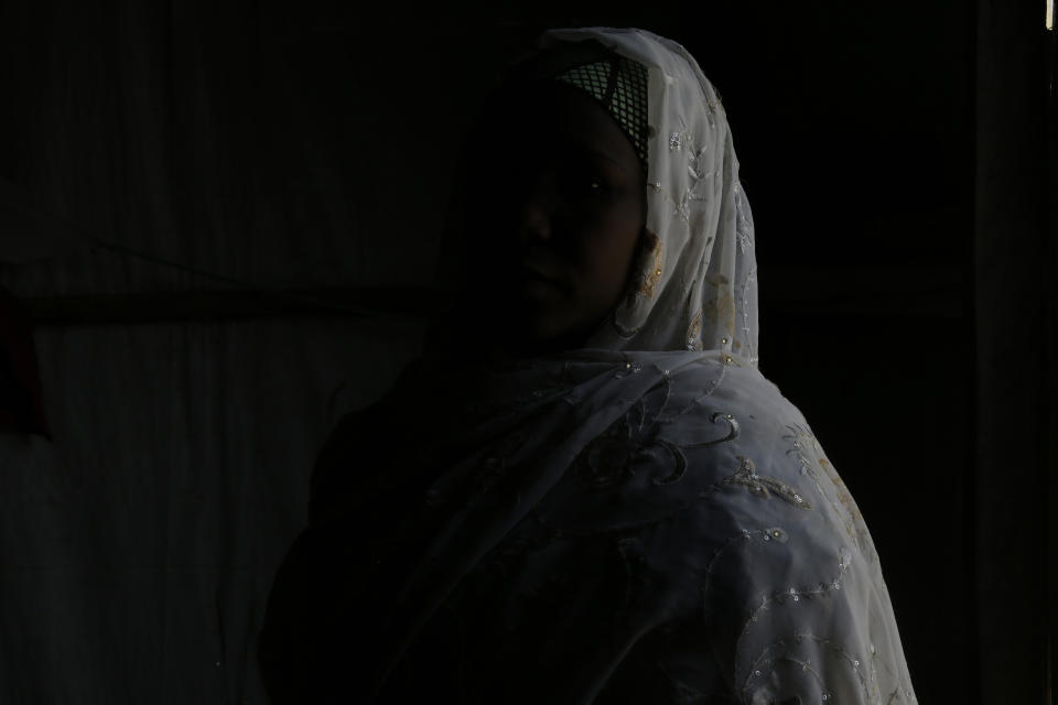 In this photo taken on Thursday, Feb. 21, 2019, Maria Saleh a woman who says she was assaulted and displaced by Islamist extremist is photographed at Malkohi camp in Yola, Nigeria. Maria is from the town of Madagali in Adamawa, has a child by a Boko Haram fighter who assaulted and then enslaved her for months following a 2014 attack that killed her husband. Two of her children were taken by militants. (AP Photo/ Sunday Alamba)