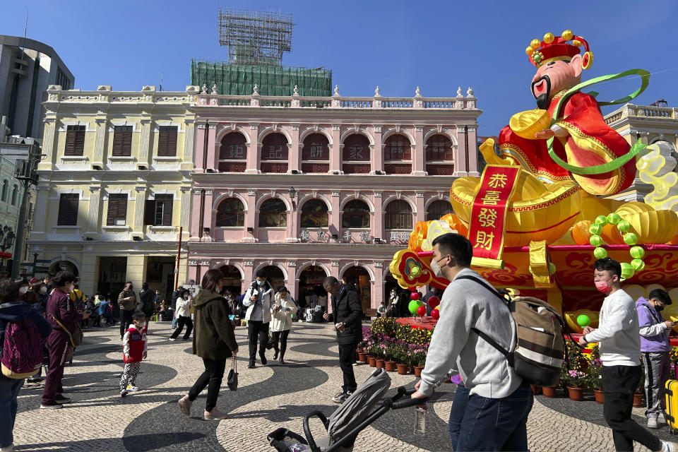 Travelers from mainland China walk around Senado Square, a tourist destination in Macao, Wednesday, Jan. 18, 2022. A hoped for boom in Chinese tourism over next week's Lunar New Year holidays looks set to be more of a blip as most travelers avoid traveling overseas, if at all. (AP Photo/Kanis Leung)