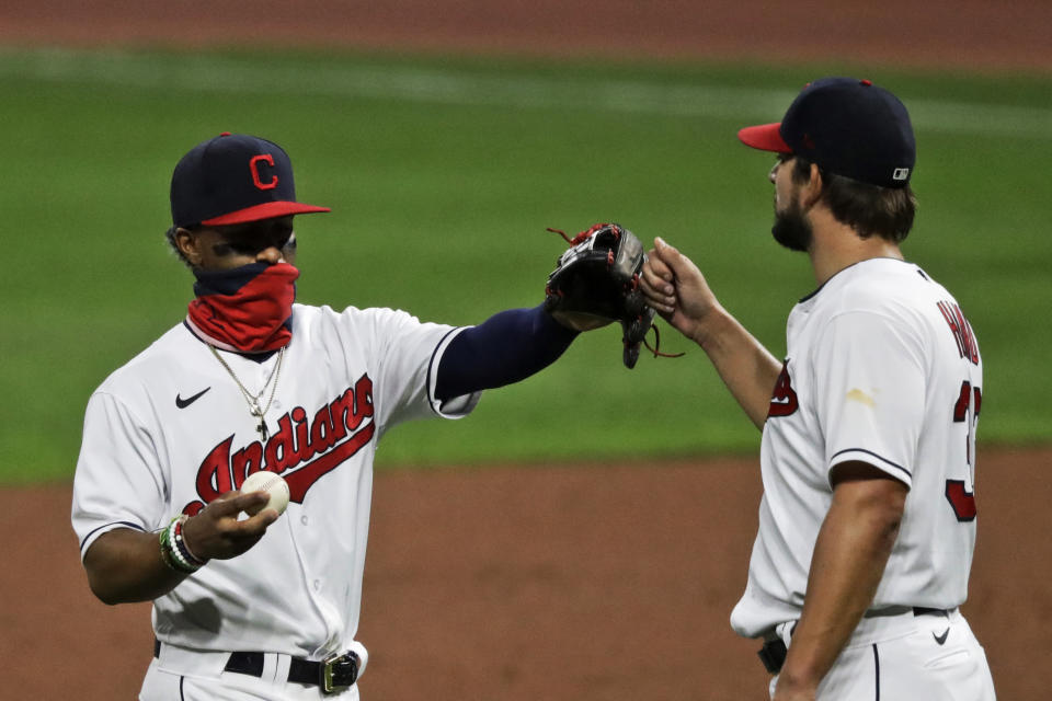 Cleveland Indians' Francisco Lindor, left, and relief pitcher Brad Hand celebrate after the Indians defeated the Minnesota Twins in a baseball game, Tuesday, Aug. 25, 2020, in Cleveland. (AP Photo/Tony Dejak)