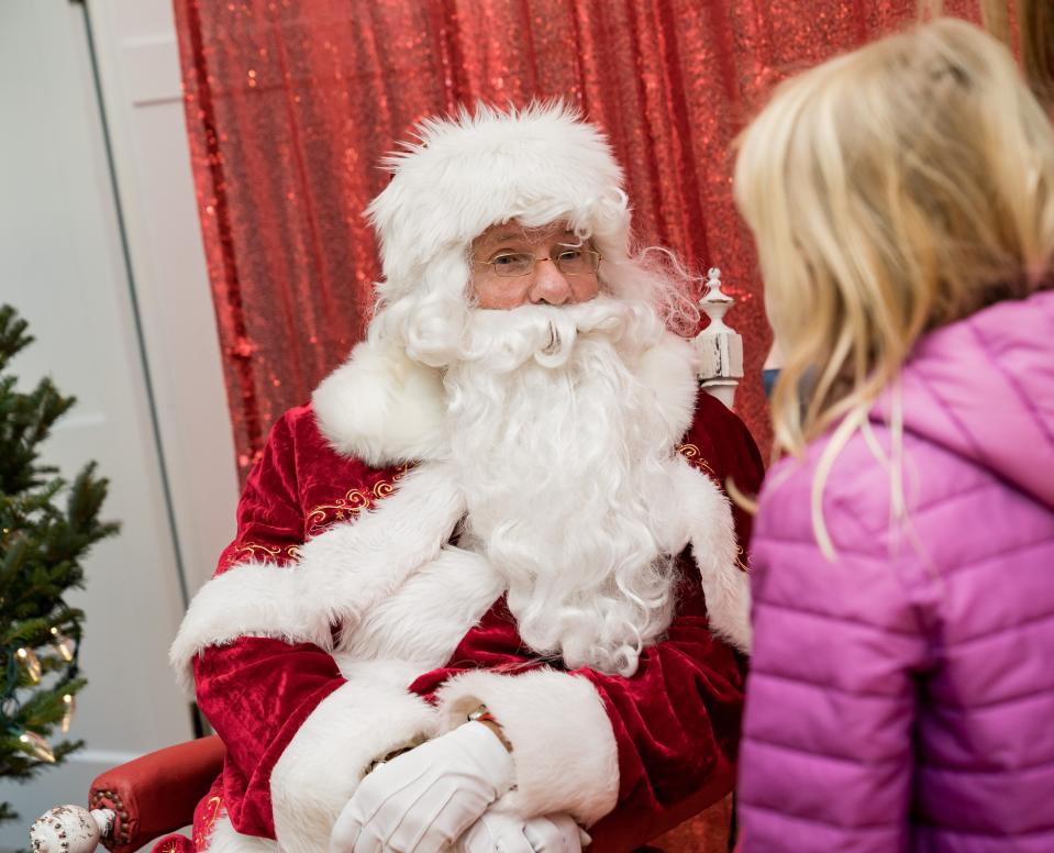 Santa Claus gets a visit from a wishful youth at Village Hall during last year's "Christmas in the Village" holiday celebration in Ephraim.