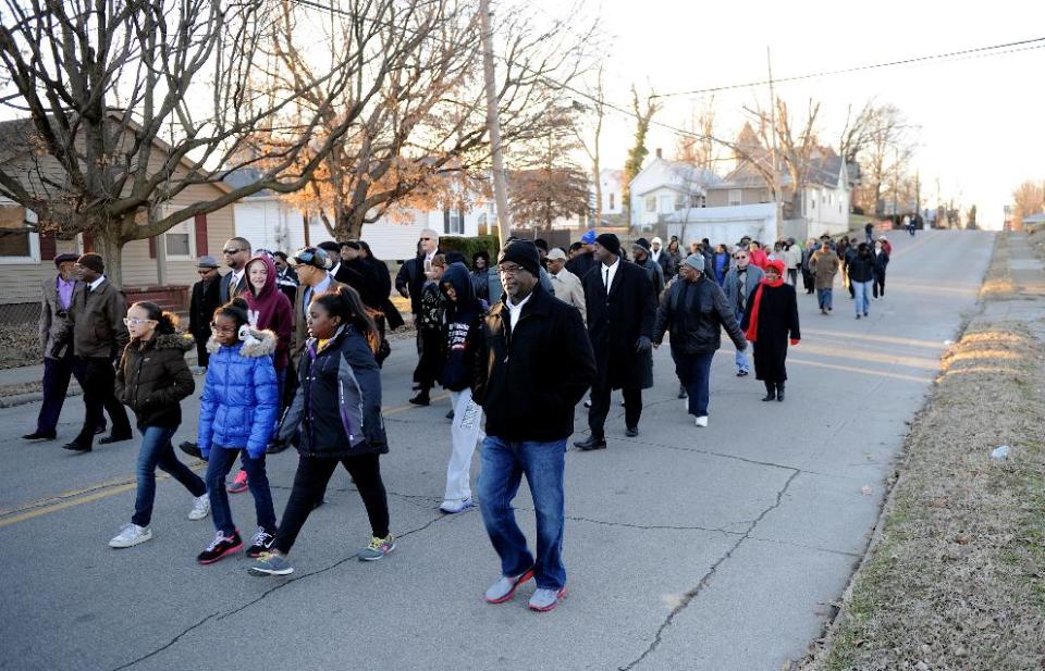 People march down Washington Street towards Greater Norris Chapel Baptist Church during the Henderson County Black History Committee's Celebration of Dr. Martin Luther King, Jr's birthday in Henderson, Ky. Sunday Jan. 19, 2014. (AP Photo/The Gleaner, Darrin Phegley)