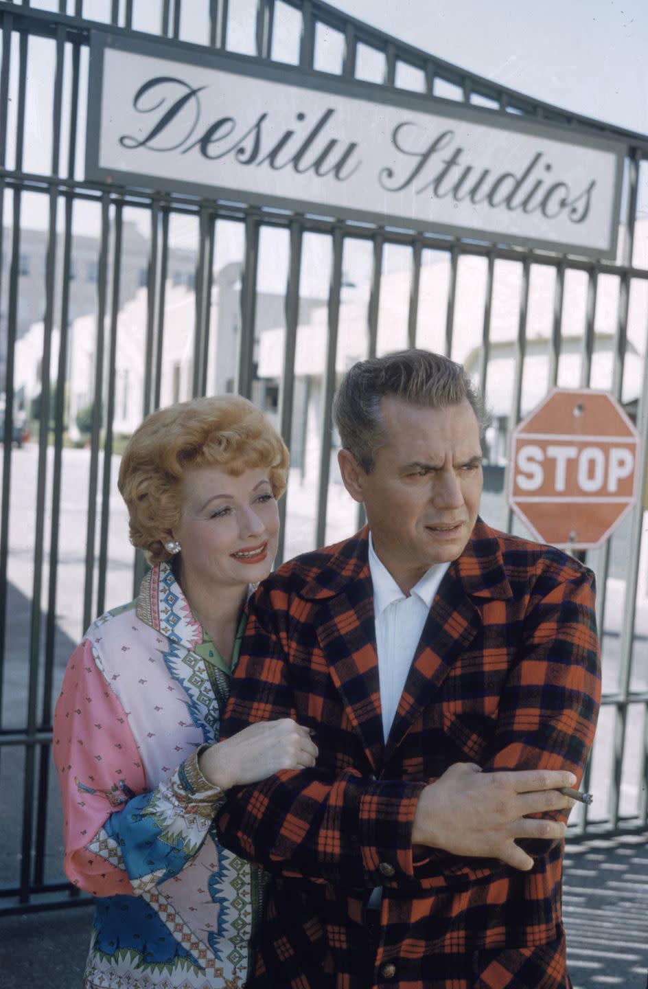 1958: Posing with Desi in front of the gates of Desilu Studios, their production company.