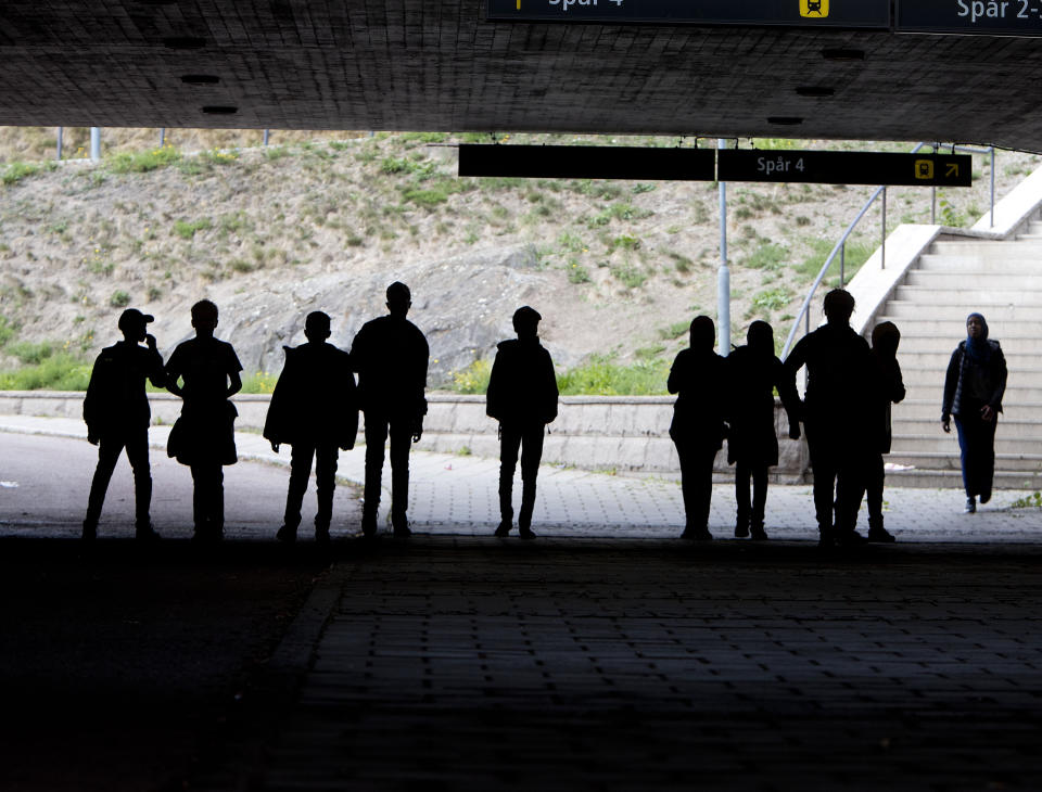 In this Aug. 30, 2018 photo migrant pupils walk under a railway bridge In Flen, some 100 km west of Stockholm, Sweden. The town has welcomed so many asylum seekers in recent years that they now make up about a fourth of the population. (AP Photo/Michael Probst)