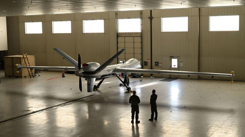 Airmen visit an MQ-9 Reaper from the California Air National Guard's 163rd Attack Wing at Springfield-Beckley Air National Guard Base, Ohio, March 18, 2024. (Airman 1st Class Colin Simpson/Air National Guard)