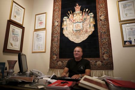 Alex Helmi, 59, owner of Damoka carpet store, which he has owned for 26 years, sits in his office in front of a Persian carpet in Westwood, Los Angeles, California, United States July 14, 2015. REUTERS/Lucy Nicholson