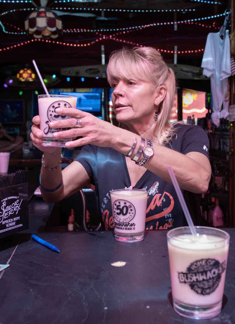 Bartender Heather Collins prepares Bushwackers at the Sandshaker in Pensacola Beach on Tuesday, Aug. 22, 2023. The lounge is celebrating its 50th anniversary.