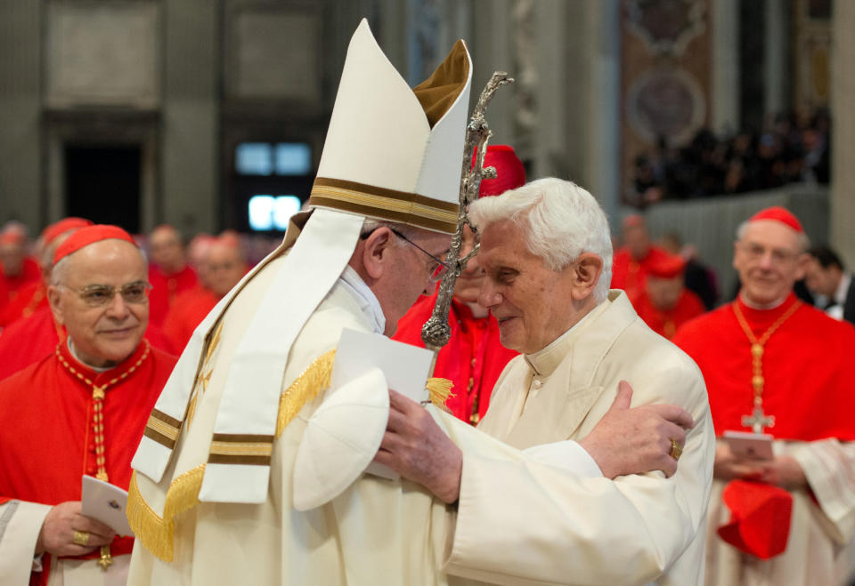 In this photo provided by the Vatican newspaper L'Osservatore Romano, Pope Francis, left, welcomes Pope Emeritus Benedict XVI during a consistory inside the St. Peter's Basilica at the Vatican, Saturday, Feb. 22, 2014. Retired Pope Benedict XVI joined Pope Francis at a ceremony Saturday creating the cardinals who will elect their successor in an unprecedented blending of papacies past, present and future. (AP Photo/L'Osservatore Romano, ho)