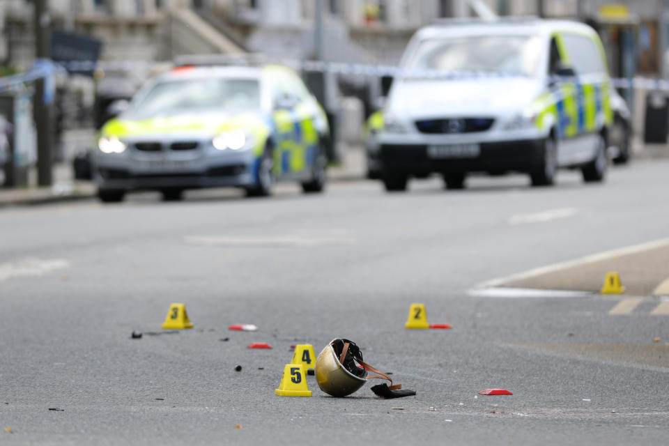 RETRANSMITTING WITH ADDED PIXELATION DUE TO GRAPHIC CONTENT. A helmet lies on the ground at a scene in Battersea, south-west London, where woman has died after being struck by a lorry while riding a scooter.