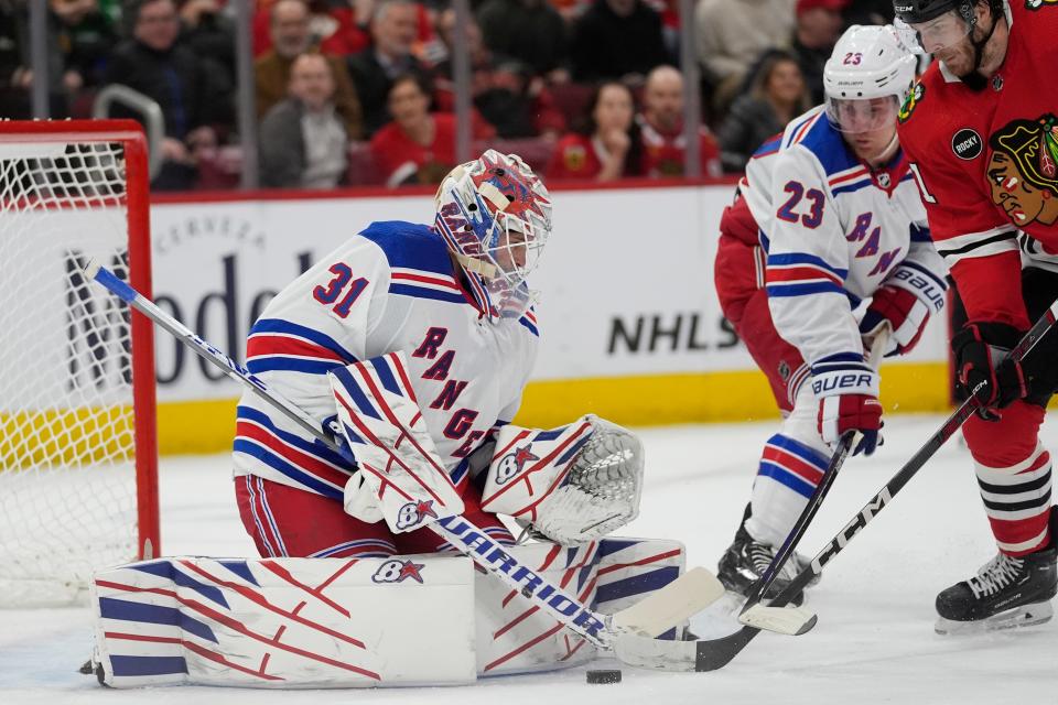 New York Rangers goaltender Igor Shesterkin makes a save against Chicago Blackhawks right wing Taylor Raddysh during the first period of an NHL hockey game, Friday, Feb. 9, 2024, in Chicago.