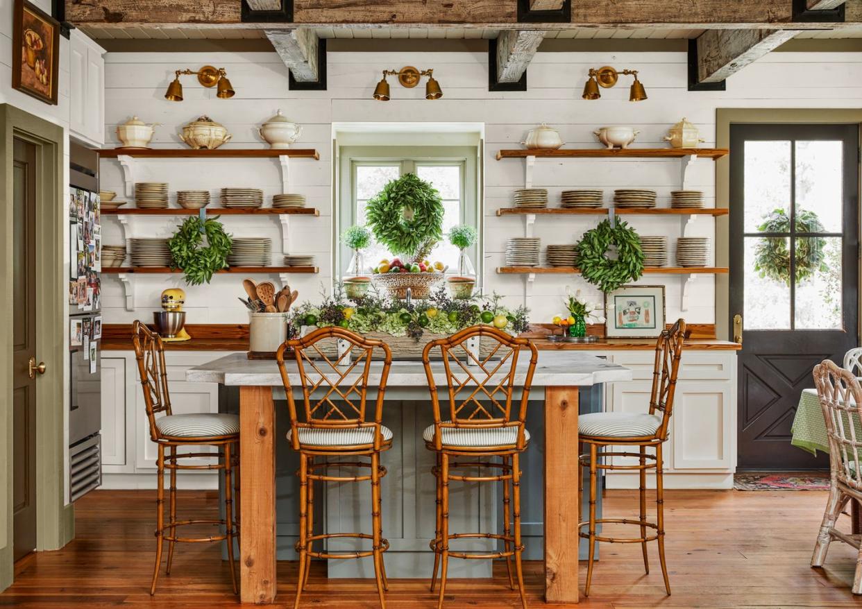 white cottage kitchen with wood shelves and green island