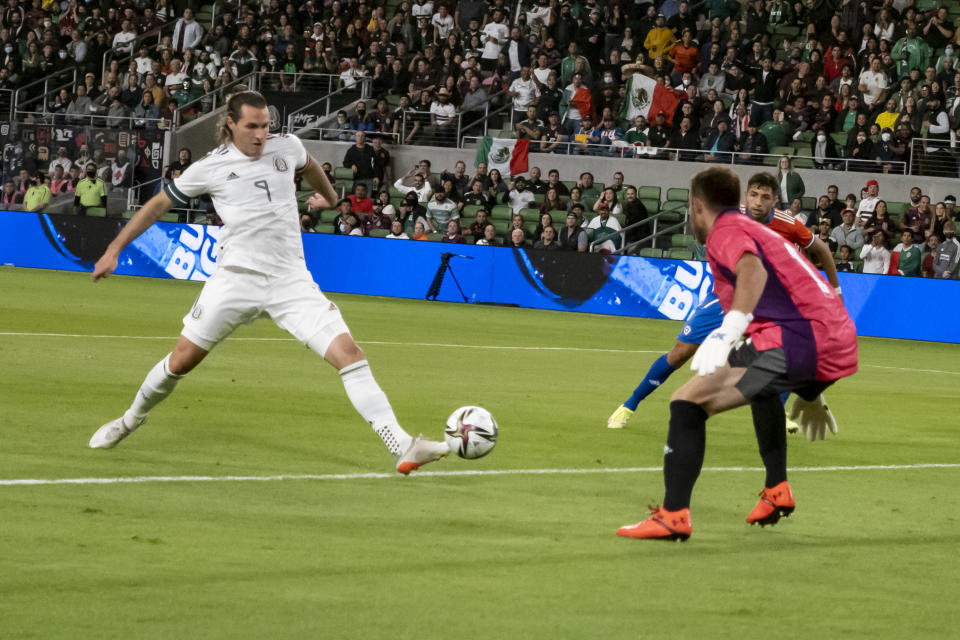 Mexico forward Santiago Tomas Gimenez (9) scores a goal against Chile goalkeeper Sebastian Perez during the first half of an international friendly soccer match Wednesday, Dec. 8, 2021, in Austin, Texas. (AP Photo/Michael Thomas)