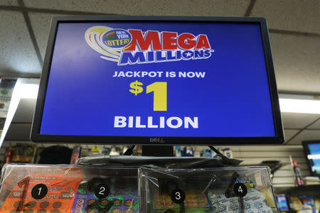 A sign displays the jackpots for Mega Millions lottery drawing in midtown Manhattan in New York, U.S., October 19, 2018. REUTERS/Mike Sugar