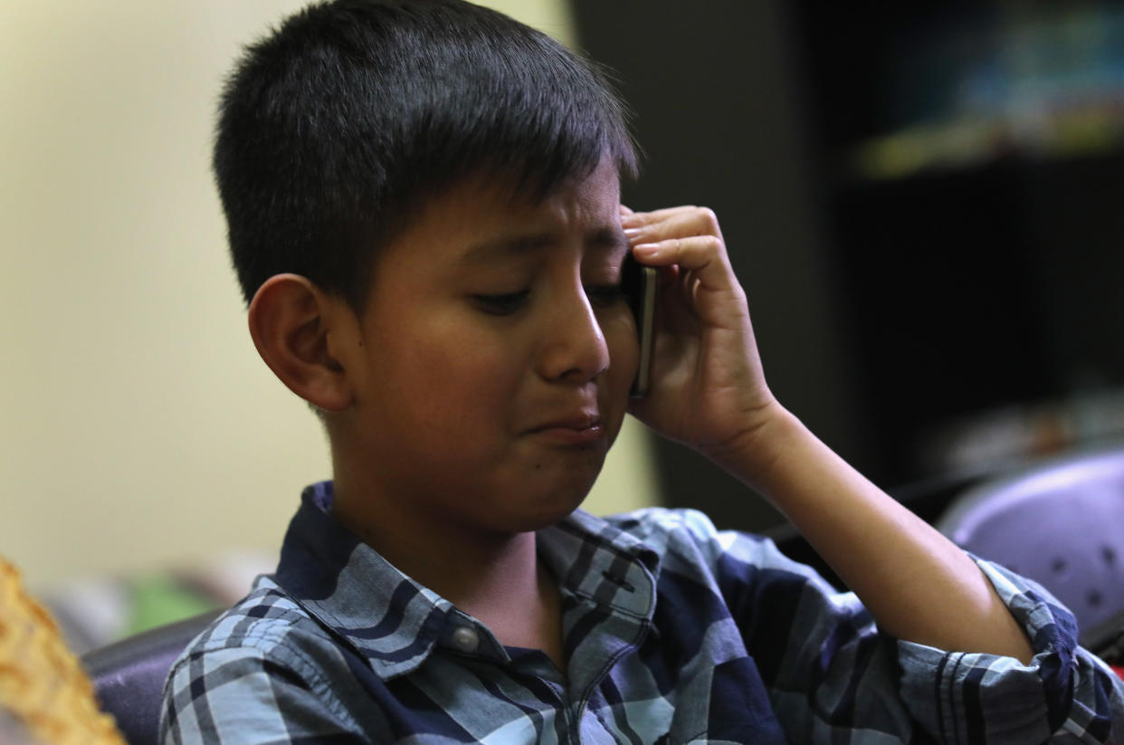 A 10-year-old child speaks with his mother on the phone after he was reunited with his father at the Nuestras Raices immigrant center on Aug. 7, 2018 in Guatemala City, Guatemala. (Photo: John Moore via Getty Images)