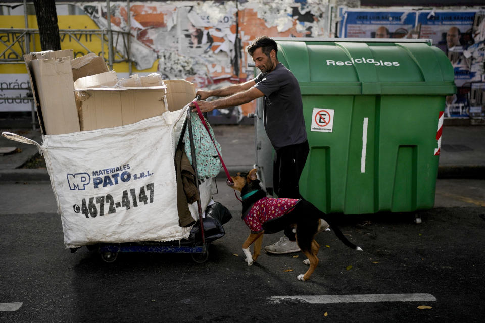 A man who identified himself only as Sebastian walks with his dog Roco as he searches for cardboard to recycle in Buenos Aires, Argentina, Thursday, May 11, 2023. According to a recent World Bank Food Security report, Argentina has seen a 107% annual inflation rate in food prices. (AP Photo/Natacha Pisarenko)