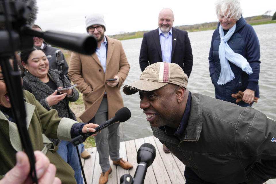 FILE - Sen. Tim Scott, R-S.C., laughs with reporters after touring the Linda Juckette farm Saturday, April 22, 2023, in Cumming, Iowa. Scott has filed paperwork to enter the 2024 Republican presidential race. He'll be testing whether a more optimistic vision of America’s future can resonate with GOP voters who have elevated partisan brawlers in recent years. (AP Photo/Charlie Neibergall, File)