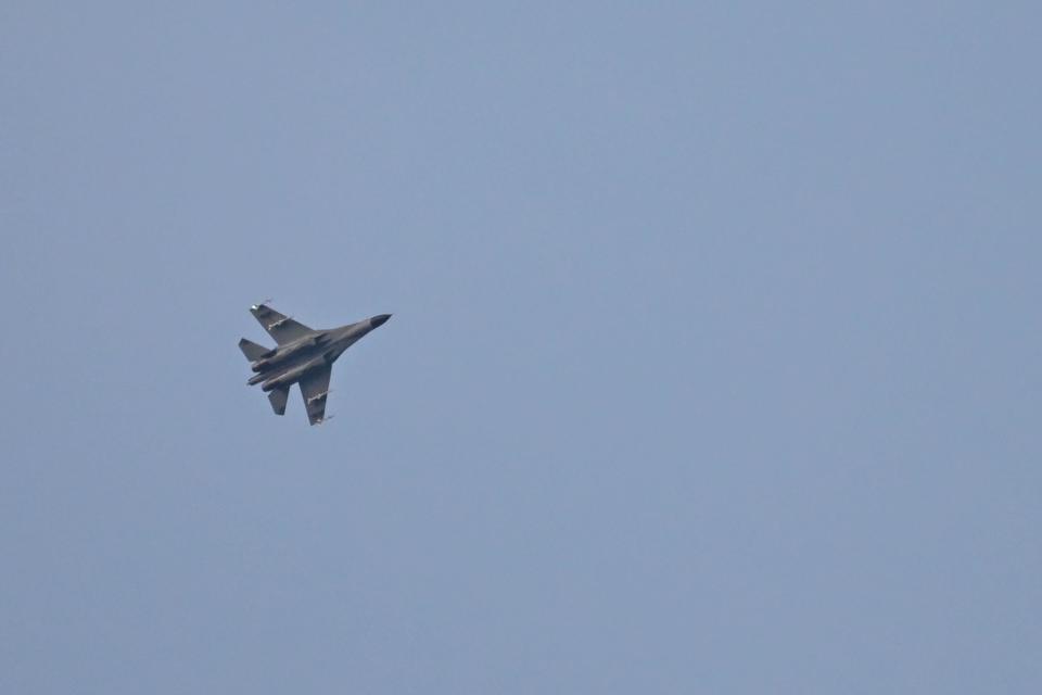 A Chinese military jet flies over Pingtan island, one of mainland China's closest points to Taiwan, in Fujian province, August 6, 2022. / Credit: HECTOR RETAMAL/AFP/Getty