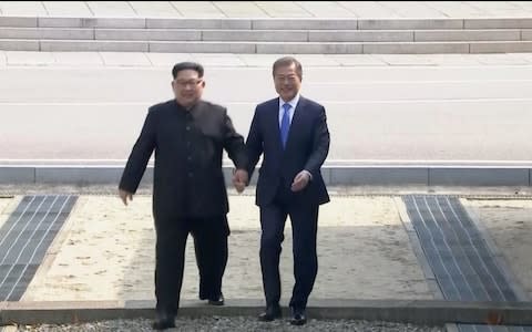 North Korean leader Kim Jong Un and South Korean President Moon Jae-in walk across the military demarcation line ahead of the inter-Korean summit - Credit: Reuters