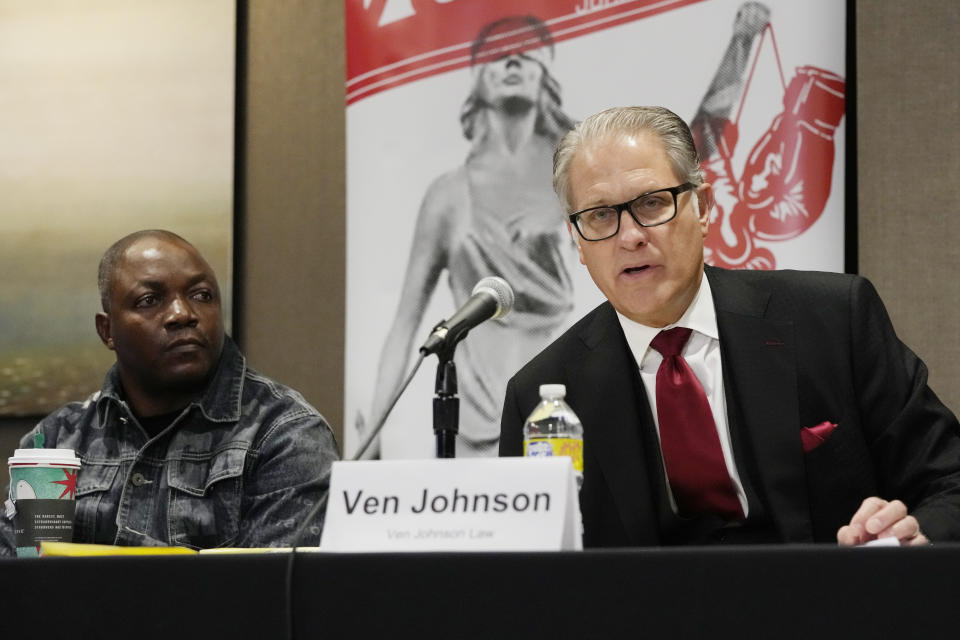 Attorney Ven Johnson sitting next to Peter Lyoya announces the filing of a civil lawsuit on behalf of Patrick Lyoya's family, Wednesday, Dec. 7, 2022, in Detroit. Civil rights and personal injury attorneys Ben Crump and Johnson announced the filing of a civil lawsuit against the City of Grand Rapids and former Grand Rapids police officer Christopher Schurr. The lawsuit alleges unnecessary, illegal and excessive force and gross negligence by then-Officer Christopher Schurr. (AP Photo/Carlos Osorio)