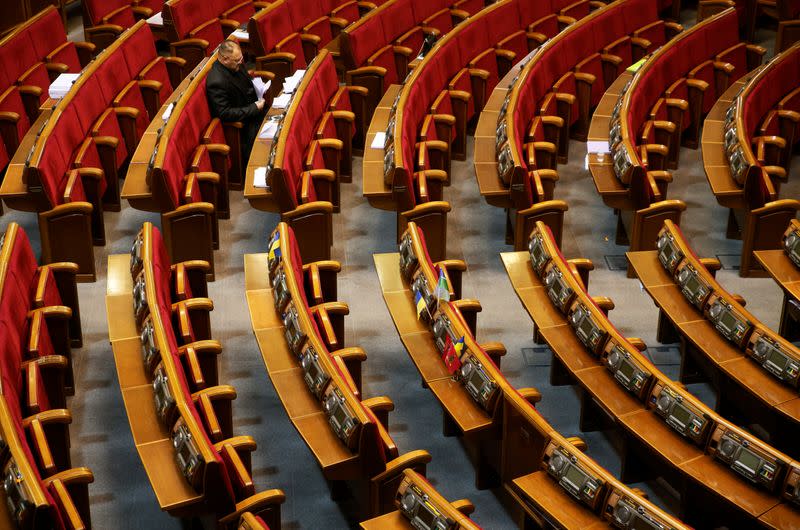 Ukrainian lawmaker waits before a session of parliament in Kiev