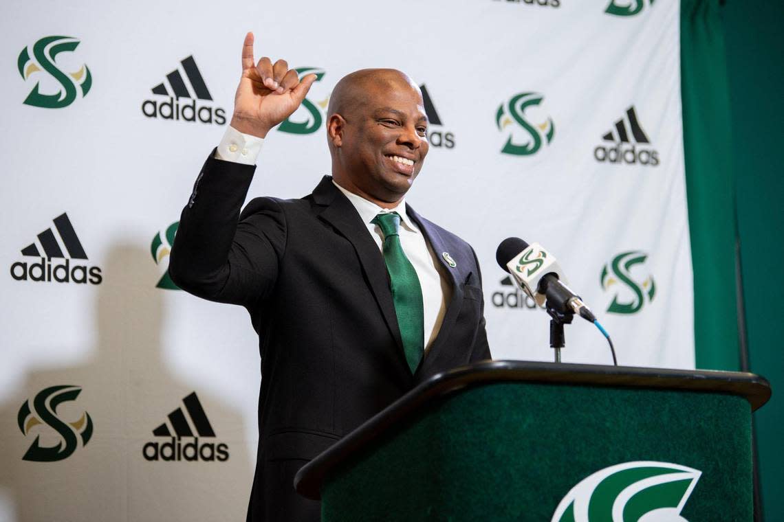 Sacramento State men’s basketball coach David Patrick signals “stingers up” during his introductory news conference with athletic director Mark Orr on April 12, 2022, in Sacramento.