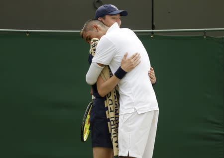 Nick Kyrgios of Australia hugs a ball boy during his match against Richard Gasquet of France at the Wimbledon Tennis Championships in London, July 6, 2015. REUTERS/Henry Browne