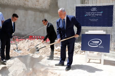 Israeli Prime Minister Benjamin Netanyahu, Mobileye founder Amnon Shashua and Minister of Economy and Industry Eli Cohen take part in a cornerstone-laying ceremony for Mobileye's center in Jerusalem